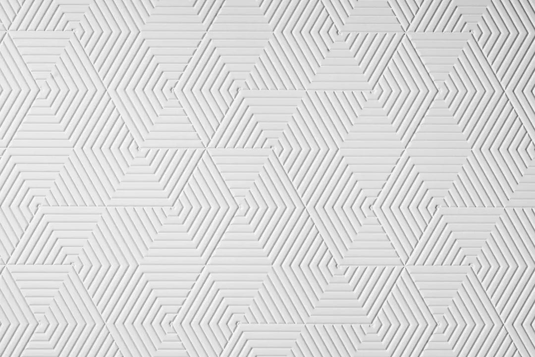 White plywood wall panel with geometric hexagonal pattern and textured surface