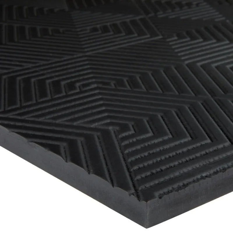 Black architectural plywood panel with geometric textured surface, close-up view