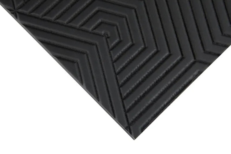 Black architectural plywood panel with geometric embossed pattern, close-up view