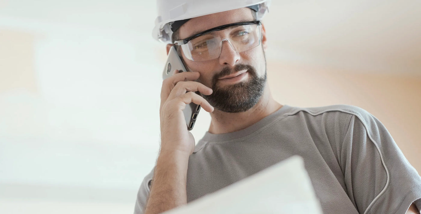 Bearded architect with a phone