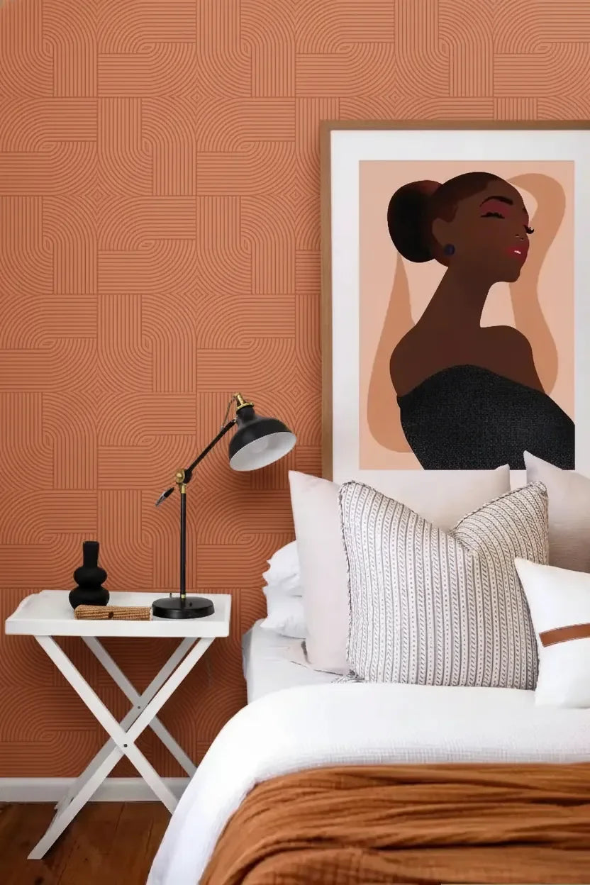 Copper patterned wall panel in modern bedroom with white side table and framed art