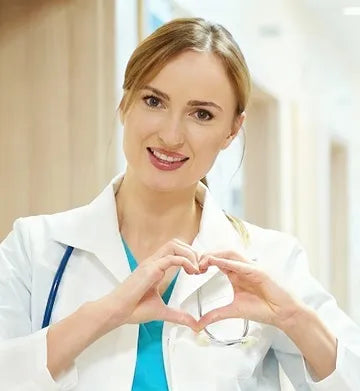 Essential services worker in a white coat making a heart shape with her hands