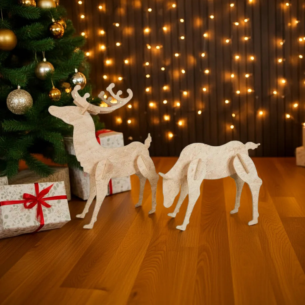 OSB3 reindeer figures in front of a decorated Christmas tree with lights on the wall.
