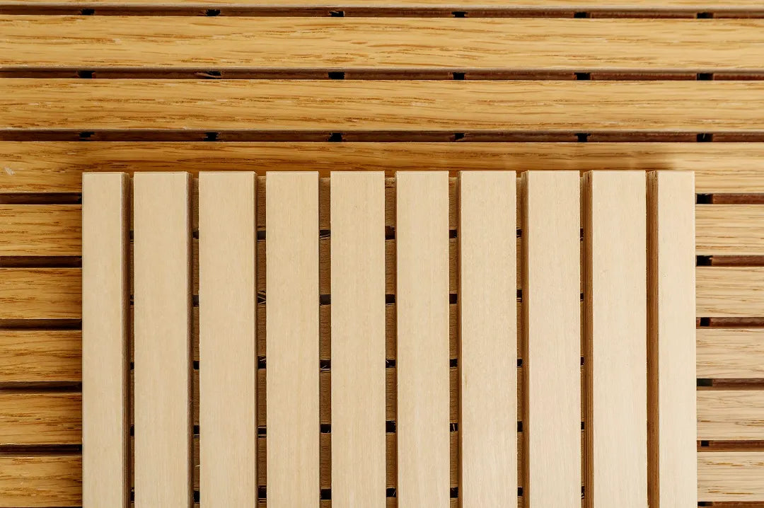 Close-up of a birch sound dampening panel sample on a wooden background