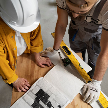 Two builders look at renovation plan