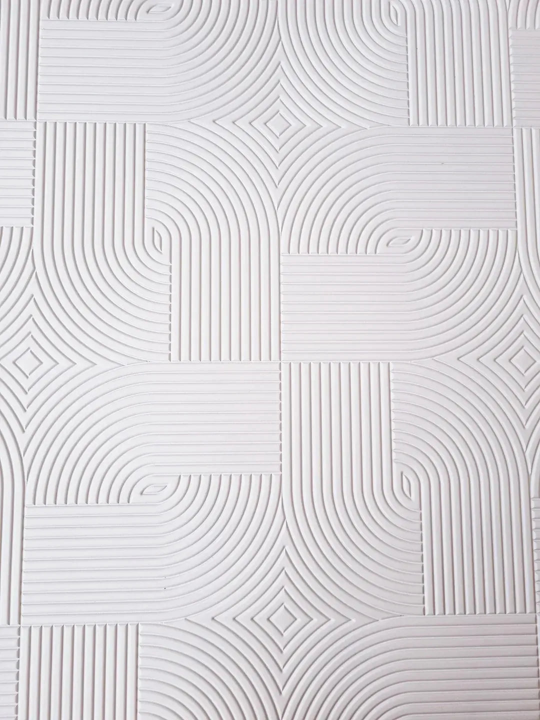 White plywood panel with geometric, curved grooves and textured surface pattern