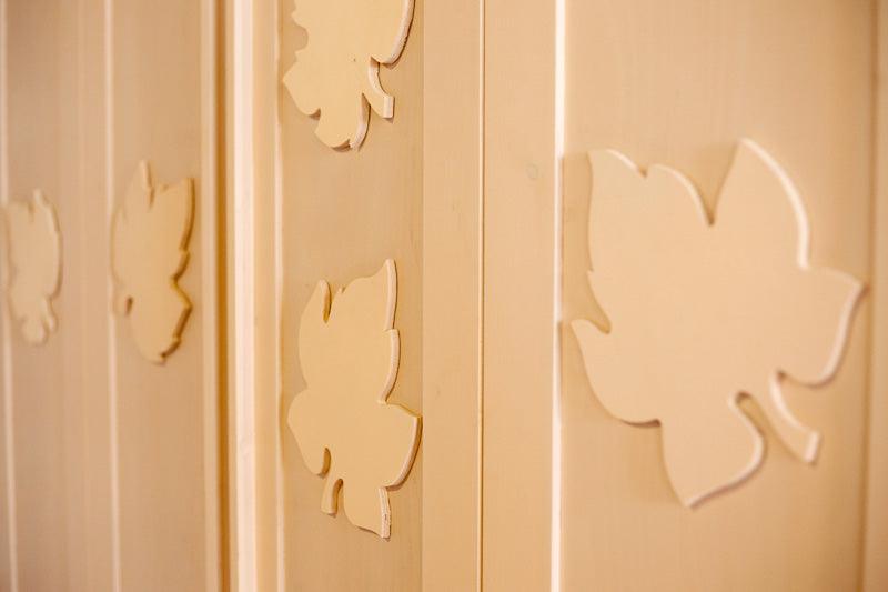 Clear coated poplar plywood panels with decorative leaf cutouts indoors