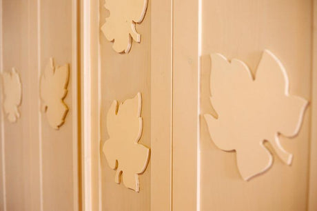 Clear coated poplar plywood panels with decorative leaf cutouts indoors