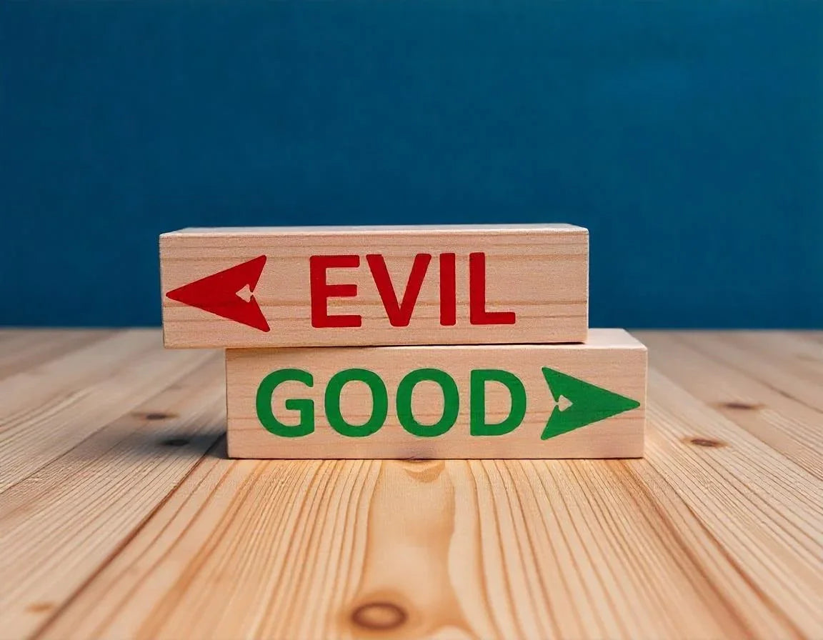 Wooden blocks on plywood with 'GOOD' and 'EVIL' text and arrows, concept for choices