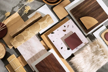 Assorted MDF material samples with wood, terrazzo, and textured finishes on a flat surface