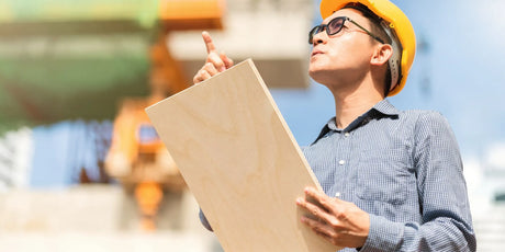 A builder with a long-grain plywood board