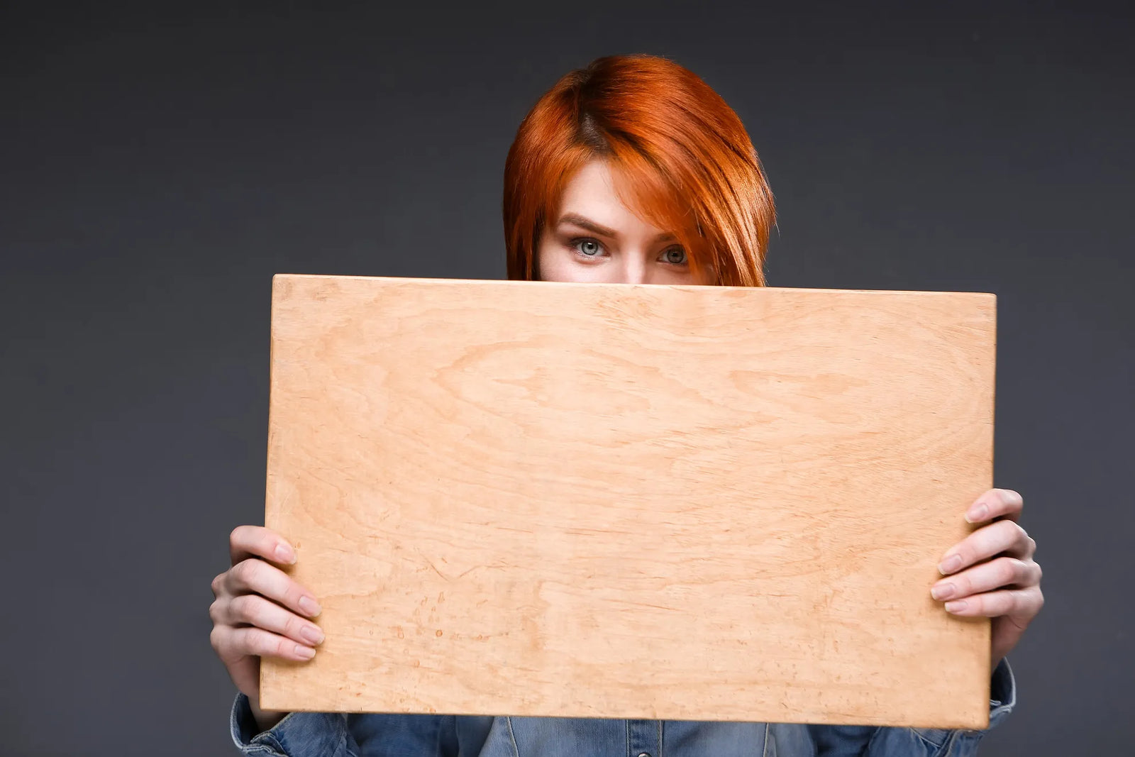 Red-haired woman with a plywood board
