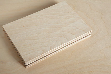 Close-up of plywood sheet showing layered wood construction and smooth finish