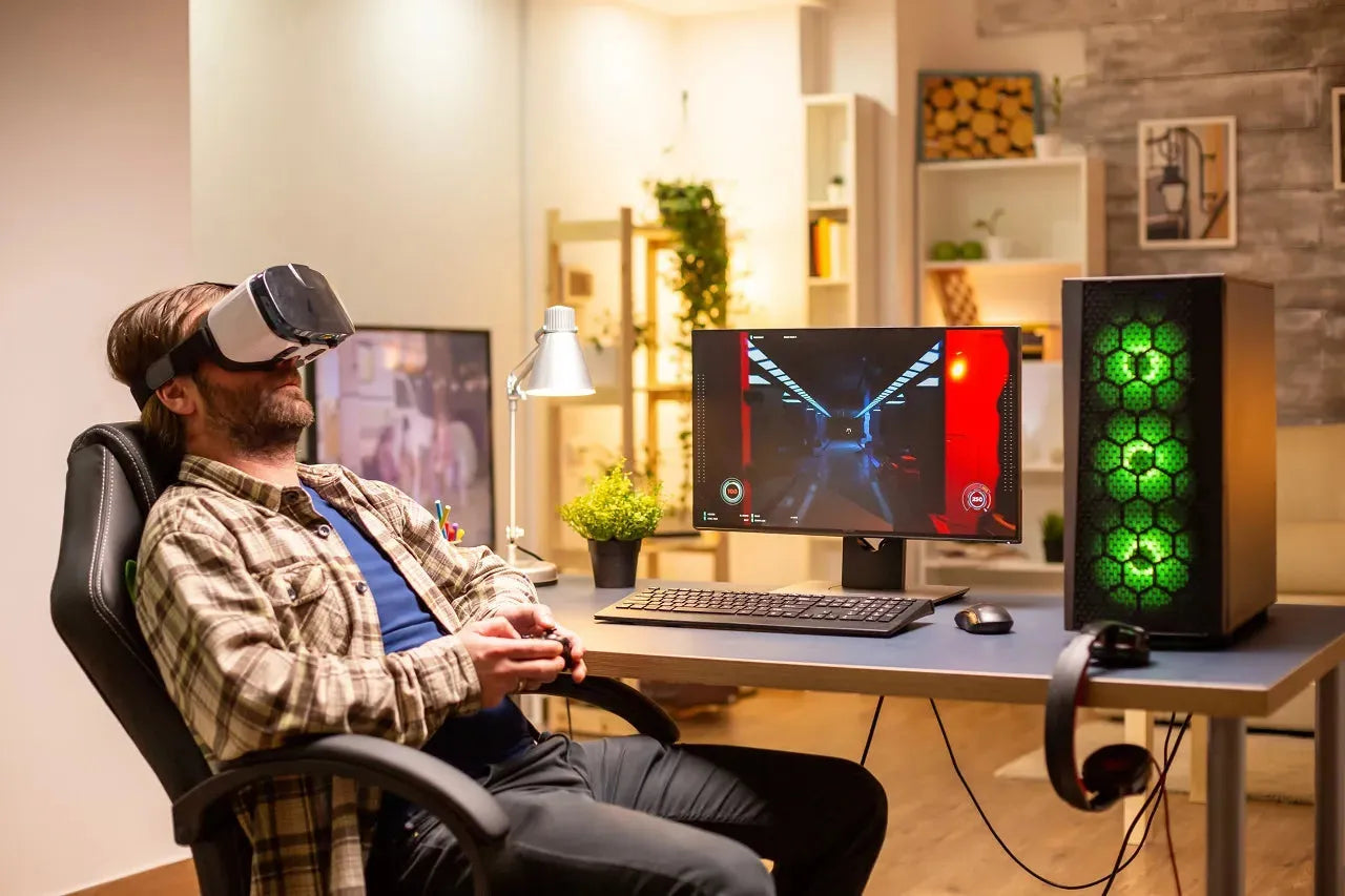 A man in VR glasses sits near plywood gaming desk