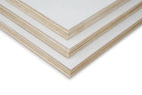 Close-up of stacked white poplar plywood sheets with smooth laminated surface