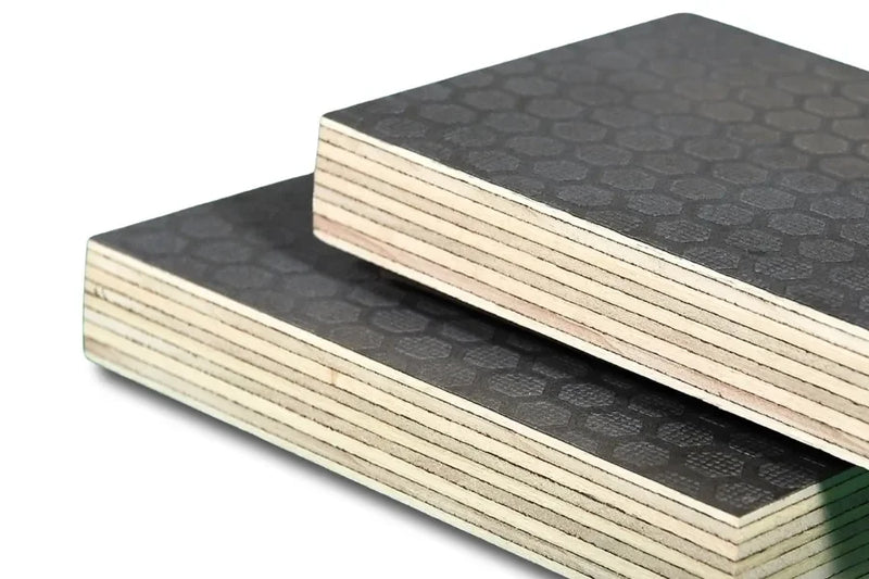 Close-up of hexagonal textured plywood sheets with layered edges, construction material