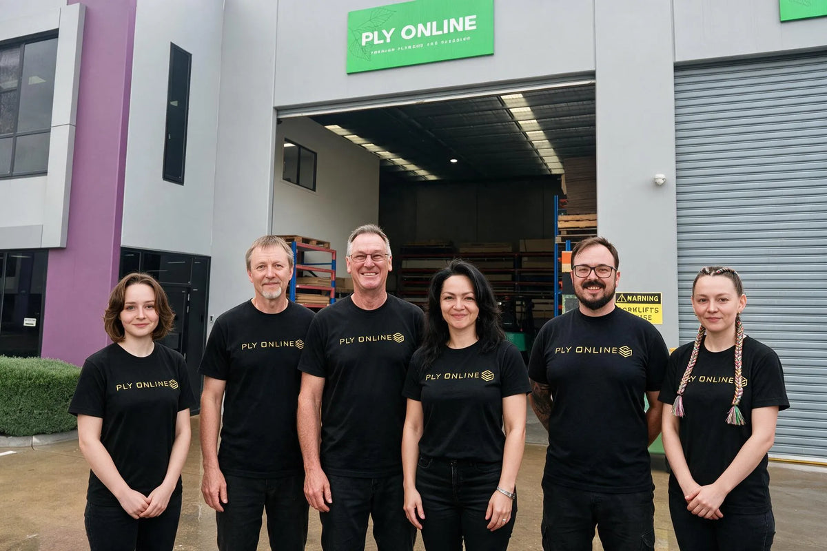 Team members standing in front of a warehouse in Braeside, wearing matching black t-shirts with the 'PLY ONLINE' logo printed in gold on the chest.