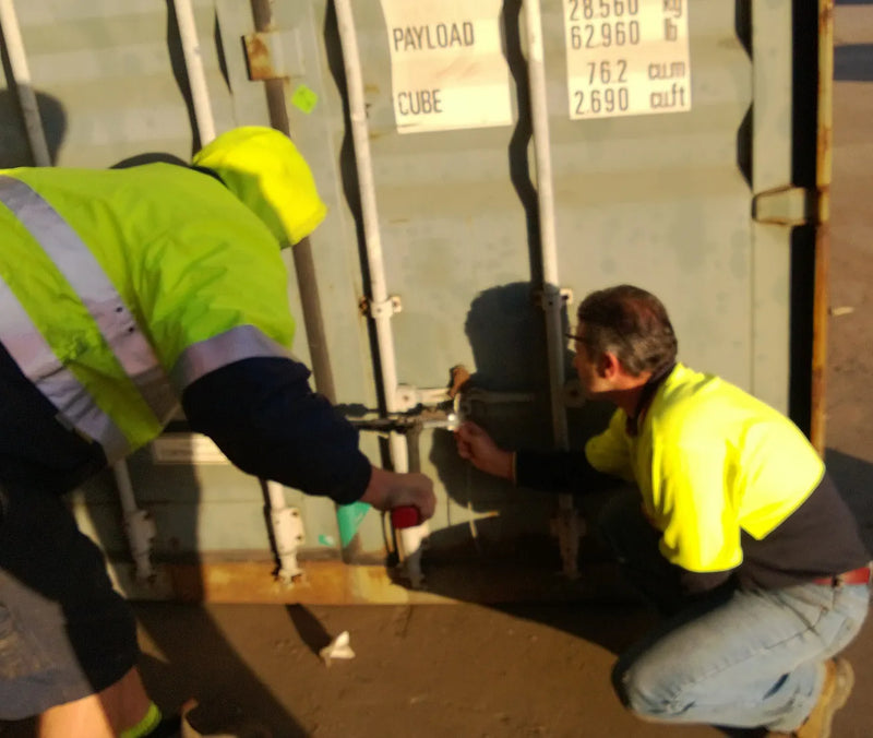 Workers unpacking the plywood sipping container at Rocky Brothers