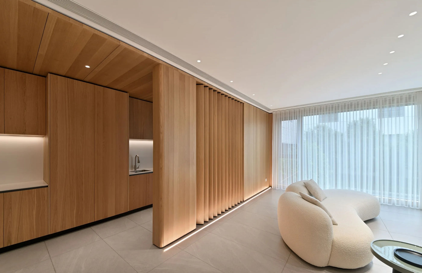 Modern living room with wood veneer panels and a white sofa - Ply Online